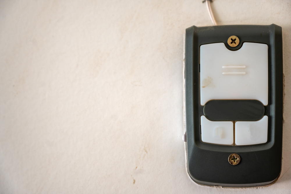 Setting Up a Garage Door Opener Button with Connecting Wires to the Mounted Box. garage door repair.