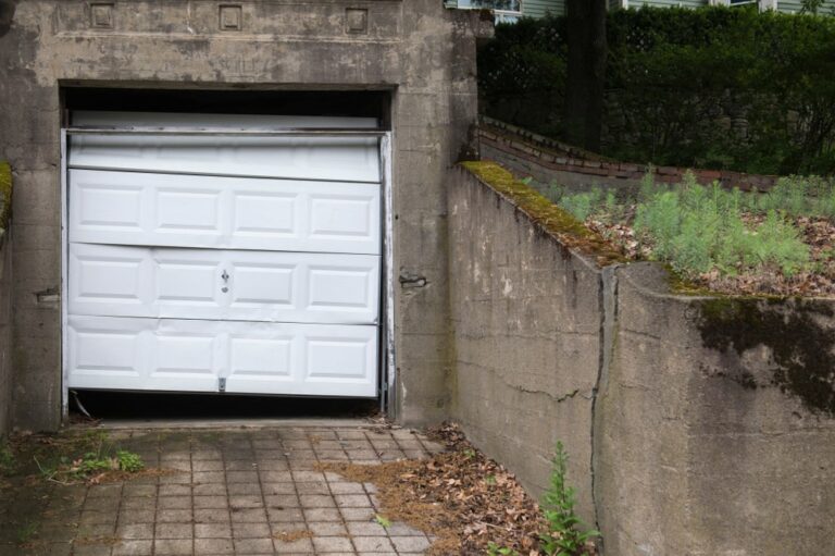 A damaged garage door, highlighting the need for urgent garage door repair services in New Orleans.