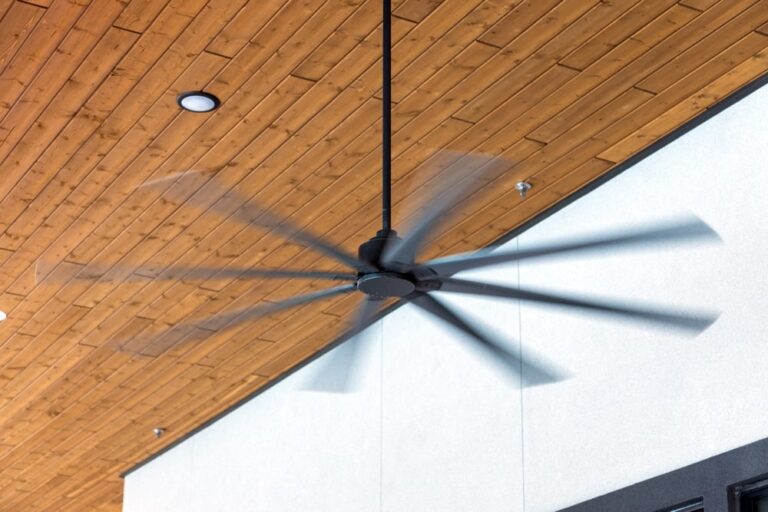 HVLS Ceiling Fans in an Industrial Setting. Large fans against a brown ceiling and white walls, optimizing air circulation and temperature control.