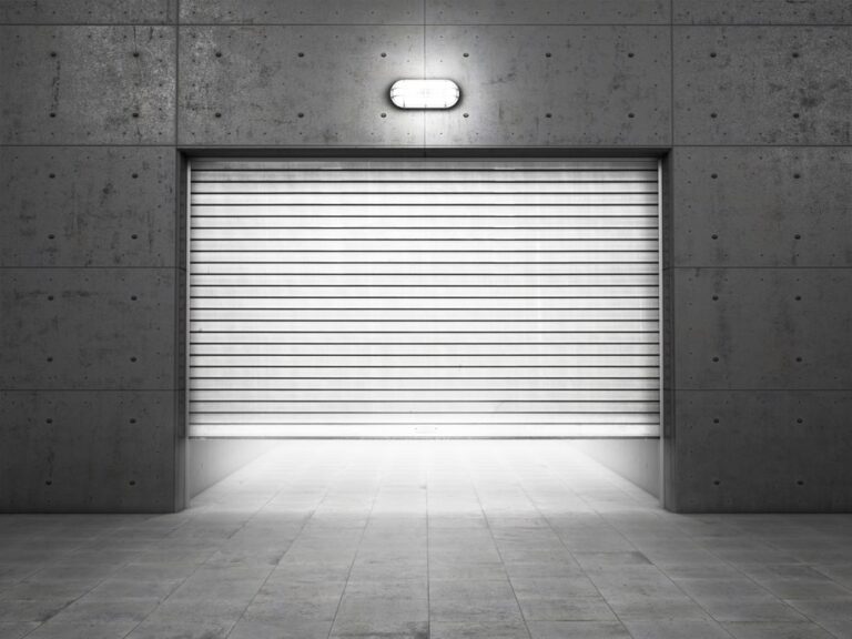 Garage building made of concrete with roller shutter doors, Top Features to Look for in an Industrial Garage Door
