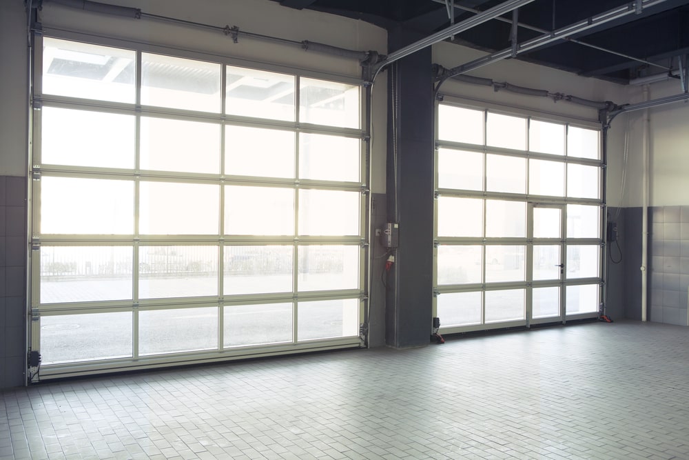 Empty interior auto-motor speedway garage door, illustrating Why Schedule a Post-Mardi Gras Inspection with Ace Garage Door in New Orleans