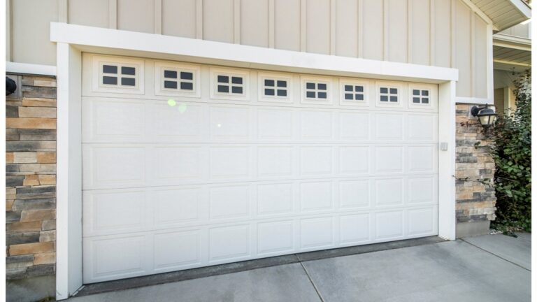 Panorama,Garage,Exterior,With,Concrete,Driveway,And,White,Sectional,Door